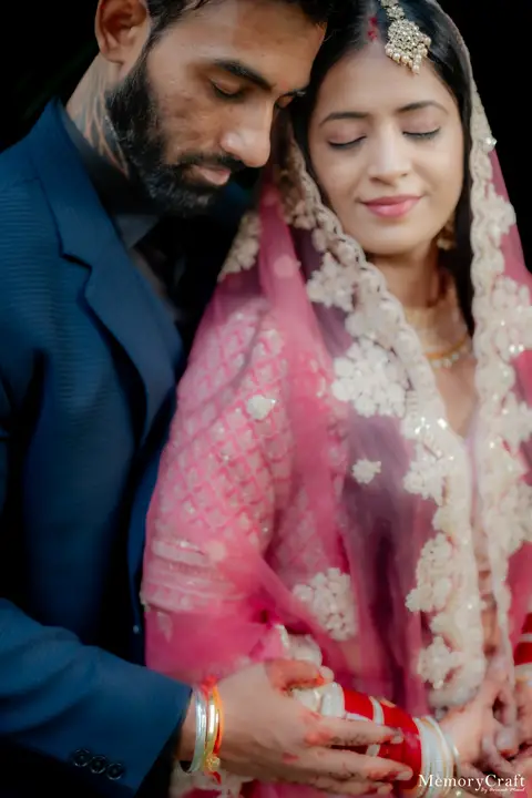 Kulwinder and Manoj: Foreheads touching.