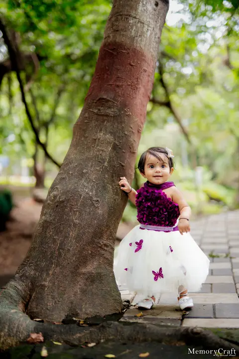 Nehal: By the tree.