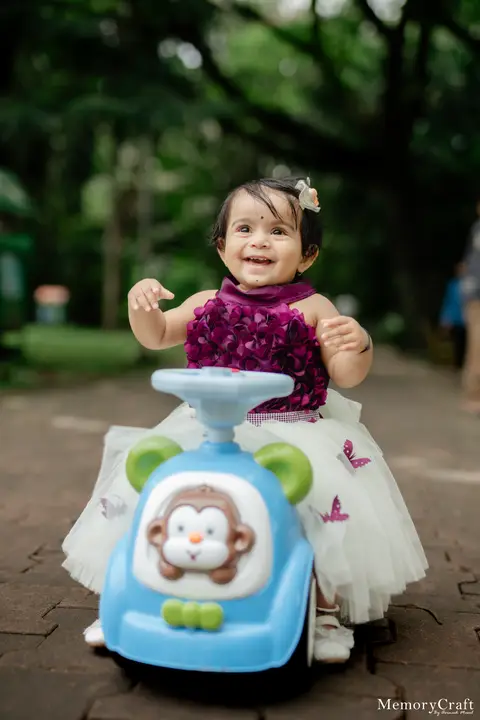 Nehal: A smile on the toy car.