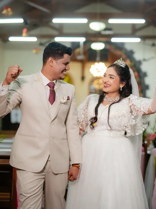 Nikhil and Nikita smiling together during their Christian wedding celebration.